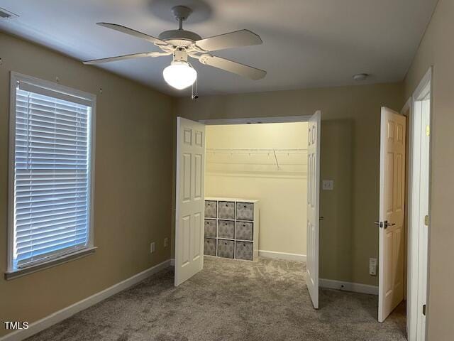 unfurnished bedroom with ceiling fan and light colored carpet