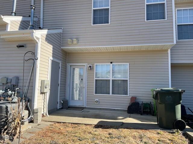 entrance to property with central AC unit and a patio