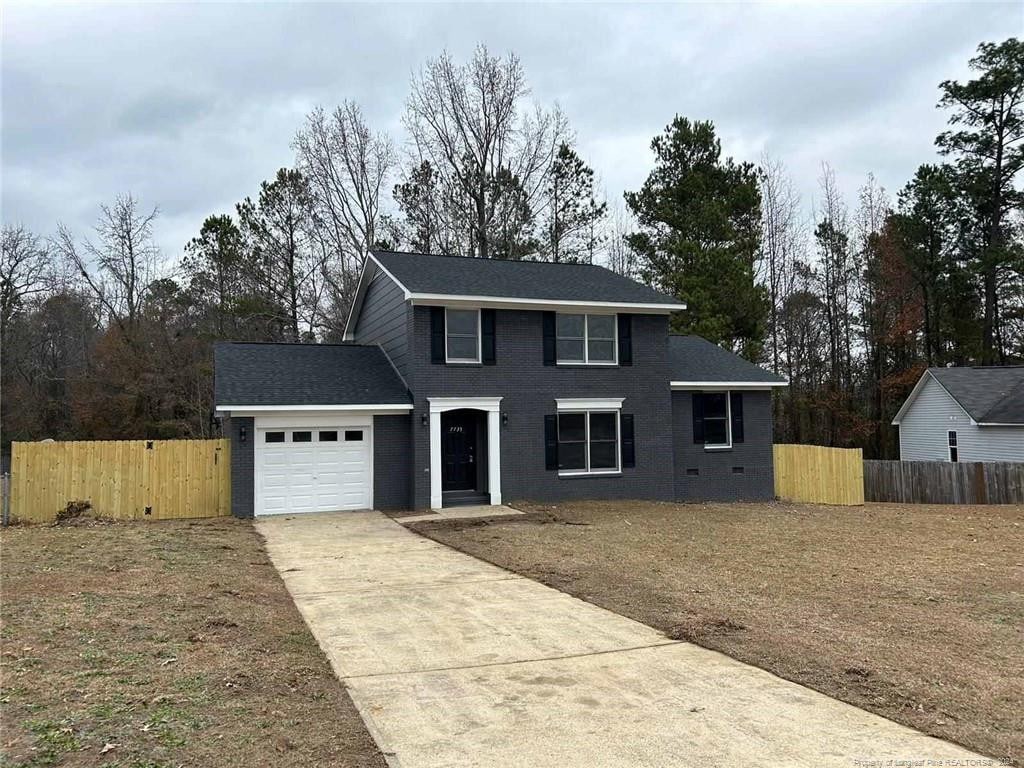 view of front property with a garage and a front yard