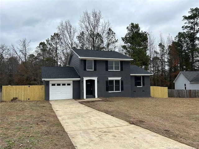 view of front property with a garage and a front yard