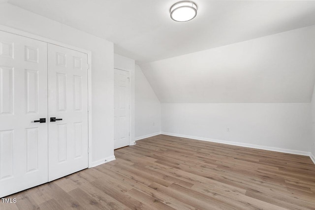 bonus room with light hardwood / wood-style floors and lofted ceiling