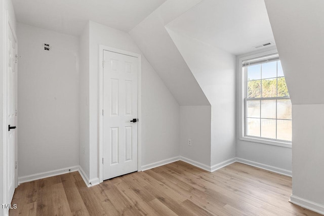 bonus room with light hardwood / wood-style flooring and lofted ceiling