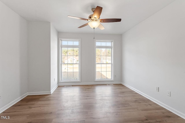 unfurnished room featuring ceiling fan and wood-type flooring