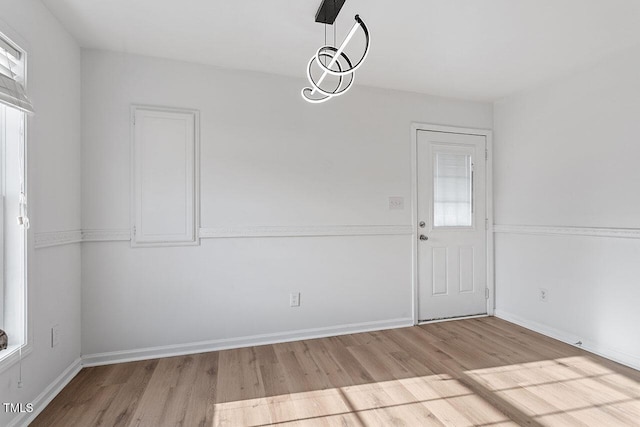 unfurnished dining area with light hardwood / wood-style floors