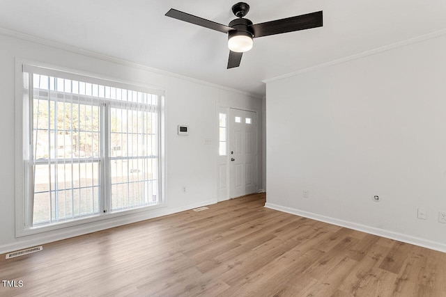 unfurnished room featuring light hardwood / wood-style flooring, ceiling fan, and crown molding