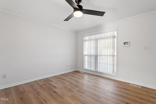 empty room with crown molding, ceiling fan, light hardwood / wood-style flooring, and a healthy amount of sunlight