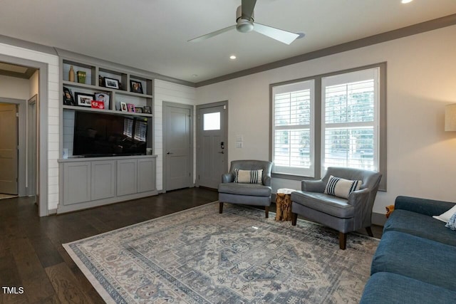 living room with ceiling fan, dark hardwood / wood-style floors, and built in shelves