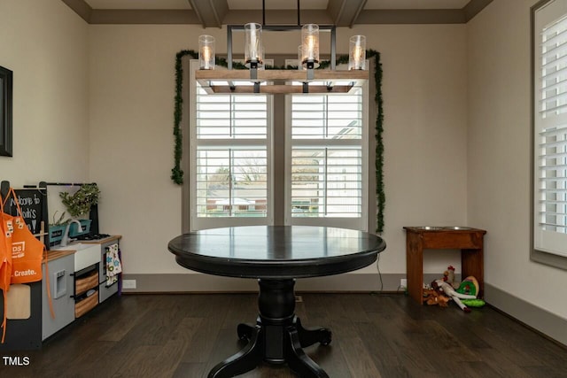 dining area featuring beamed ceiling and dark hardwood / wood-style floors