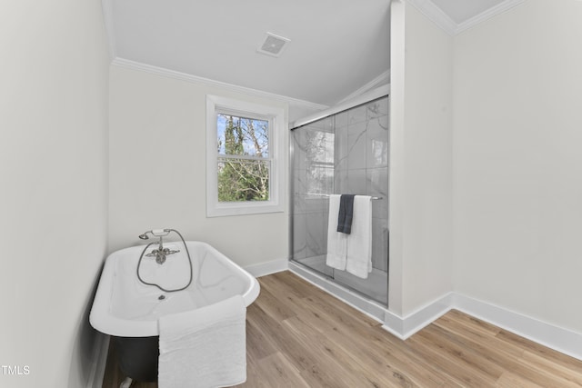 bathroom with crown molding, wood-type flooring, a shower with door, and vaulted ceiling