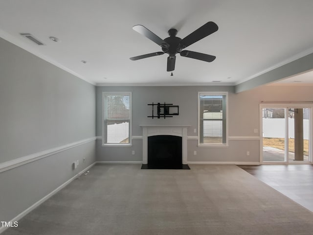 unfurnished living room with ceiling fan, crown molding, and carpet