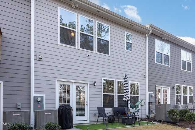 rear view of house featuring central air condition unit