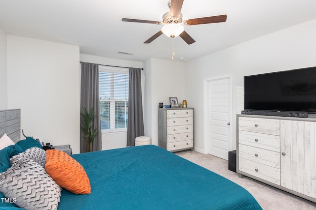 bedroom featuring light carpet and ceiling fan