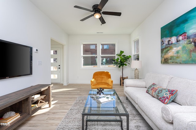 living room with ceiling fan and light hardwood / wood-style floors