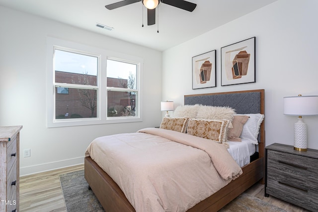 bedroom with light wood-type flooring and ceiling fan