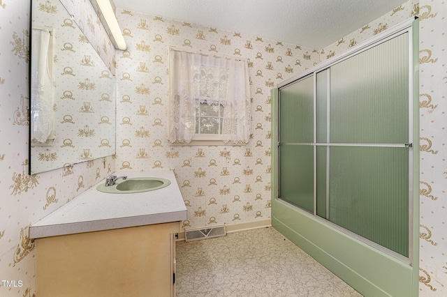 full bathroom with wallpapered walls, baseboards, visible vents, a textured ceiling, and vanity