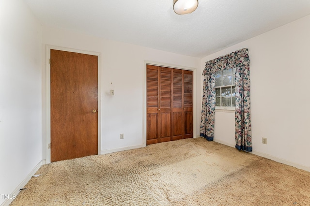 unfurnished bedroom featuring a closet, carpet, and baseboards