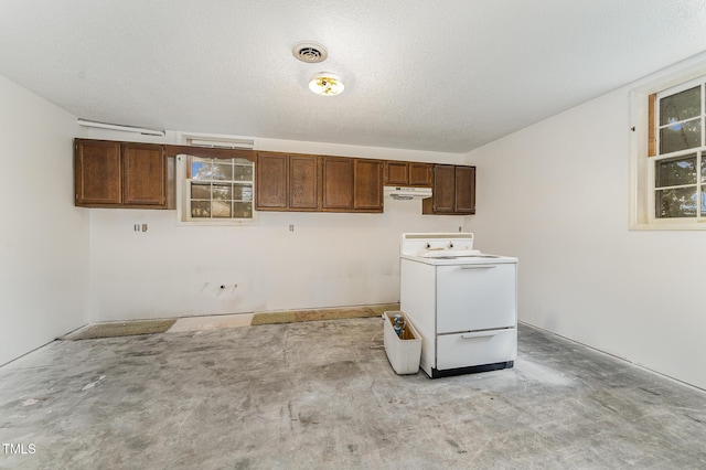 clothes washing area featuring laundry area, visible vents, washer / clothes dryer, and a textured ceiling