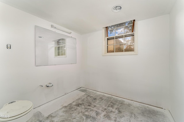 bathroom featuring visible vents, toilet, and unfinished concrete floors