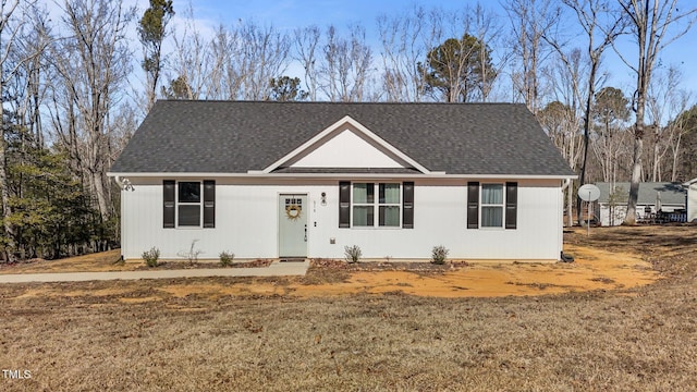 single story home featuring a front lawn