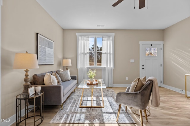 living room with ceiling fan and light wood-type flooring