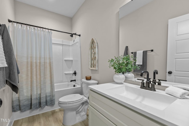 full bathroom featuring hardwood / wood-style flooring, vanity, toilet, and shower / bath combo