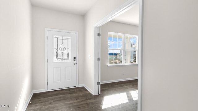 entryway with dark wood-type flooring and baseboards