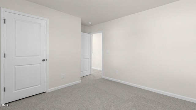 unfurnished bedroom with baseboards and carpet