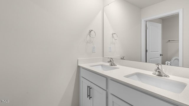 full bath with a sink and double vanity