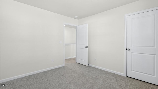 unfurnished bedroom featuring baseboards and carpet floors