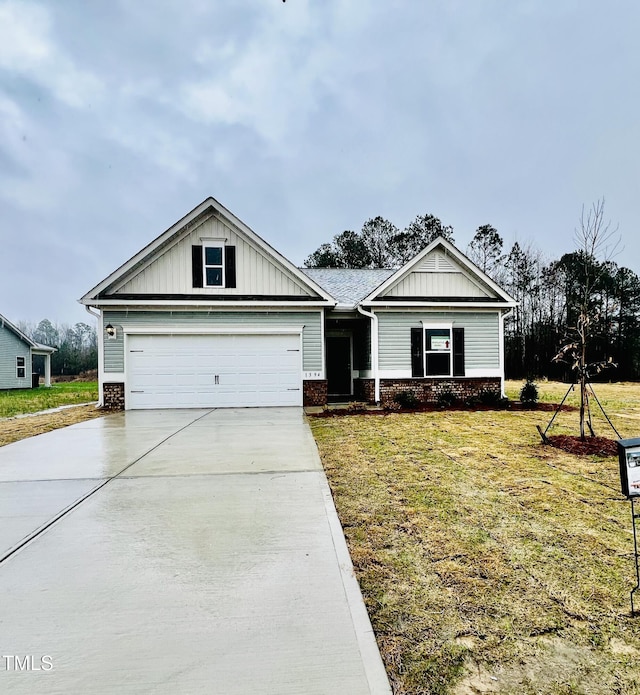 view of front of property with brick siding, board and batten siding, driveway, and a front yard