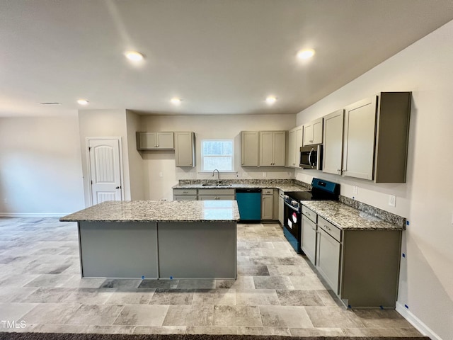 kitchen with stainless steel microwave, range with electric cooktop, gray cabinetry, dishwasher, and a sink