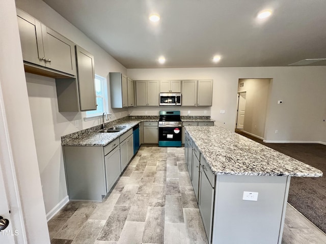 kitchen featuring a sink, appliances with stainless steel finishes, and gray cabinetry