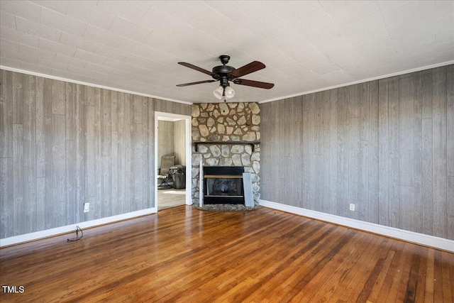 unfurnished living room featuring hardwood / wood-style flooring, a fireplace, and ornamental molding