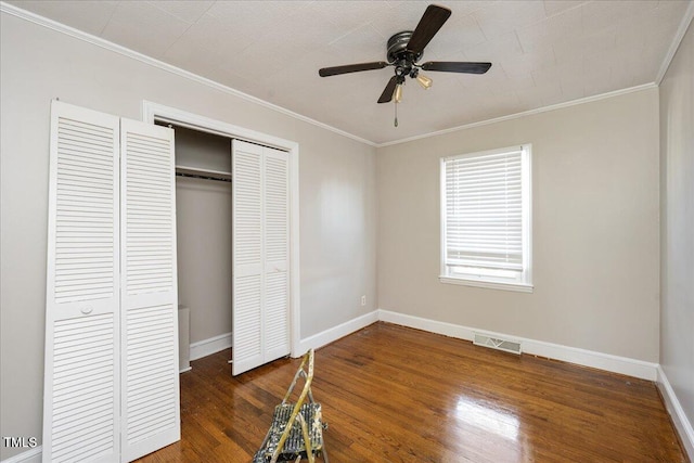 unfurnished bedroom featuring ceiling fan, dark hardwood / wood-style floors, and ornamental molding