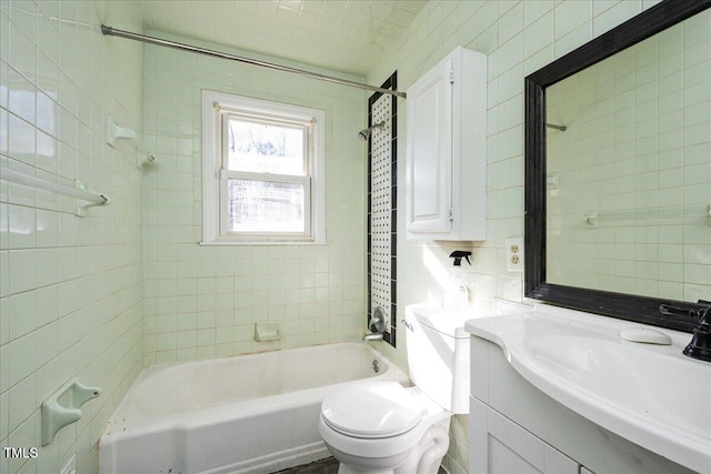 full bathroom with vanity, toilet, tiled shower / bath, and tasteful backsplash