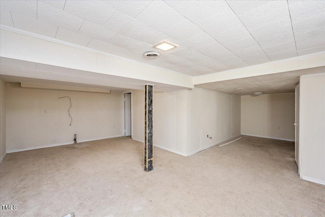 basement featuring light carpet