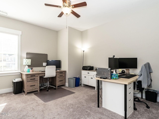 carpeted office with ceiling fan