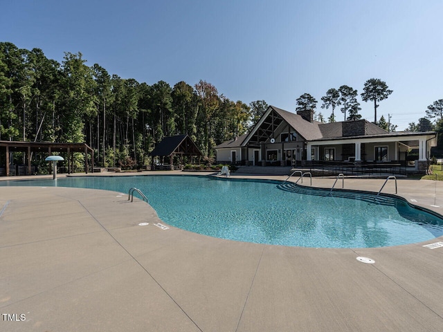 view of swimming pool featuring a patio area