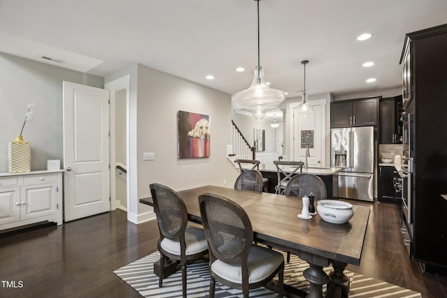 dining space with dark wood-type flooring