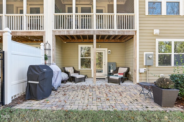 view of patio featuring area for grilling and a balcony