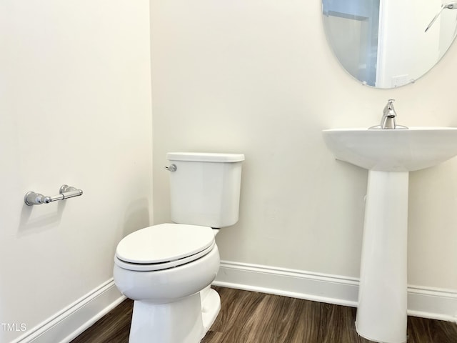 bathroom featuring hardwood / wood-style floors and toilet