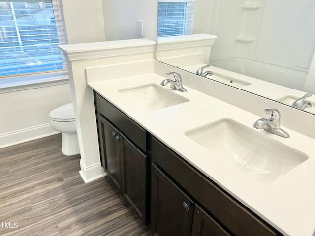 bathroom with vanity, wood-type flooring, and toilet