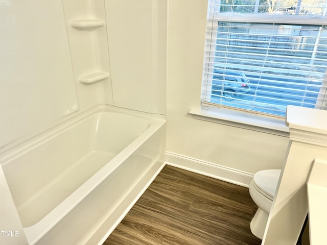 bathroom featuring hardwood / wood-style flooring and toilet