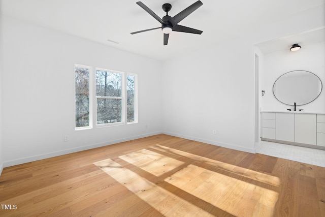 spare room featuring ceiling fan and wood-type flooring