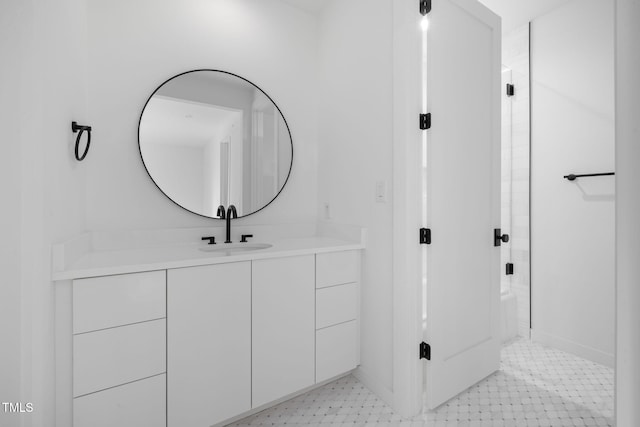 bathroom with vanity and a shower with shower door