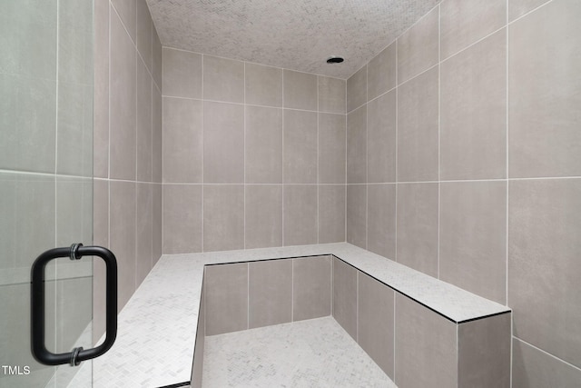 bathroom with a tile shower