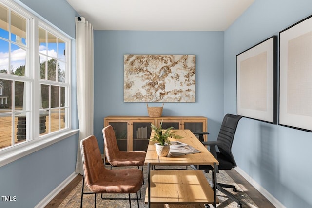 dining space with wood-type flooring