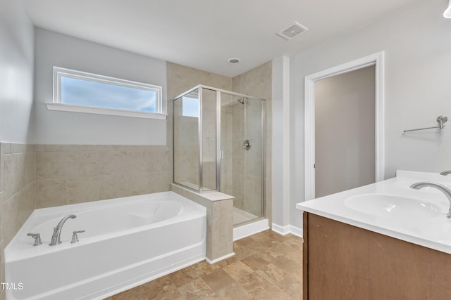 bathroom with vanity and independent shower and bath