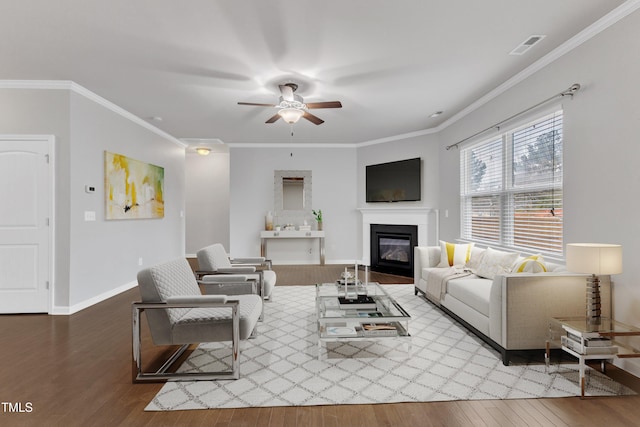 living room with ceiling fan, light hardwood / wood-style floors, and ornamental molding