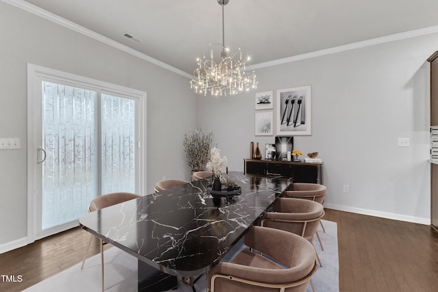 dining area featuring a chandelier, dark hardwood / wood-style floors, and ornamental molding